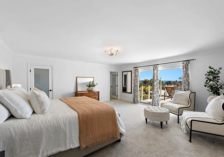 Expansive primary suite with private ocean-view balcony and retreat space. *Home will be delivered unfurnished.