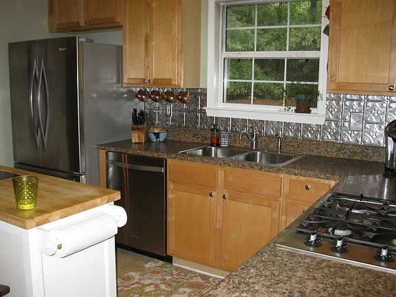 Kitchen
						:
						Features a stainless dishwasher, refrigerator and a roll away island.