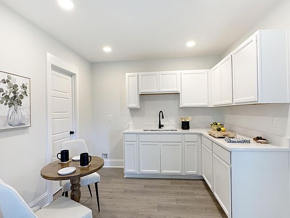 View from Living Room to Kitchenette.
There is a new full-sized refrigerator to the left of the sink, missing in this photo