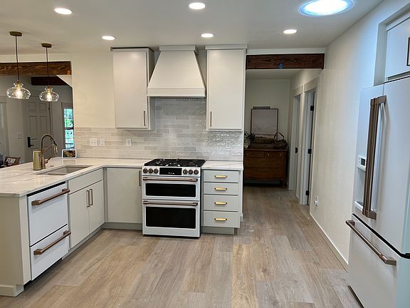 Kitchen with new high end GE Cafe Profile appliances. Double oven and gas stove. Two drawer dishwasher. Fridge with filtered water and Ice.