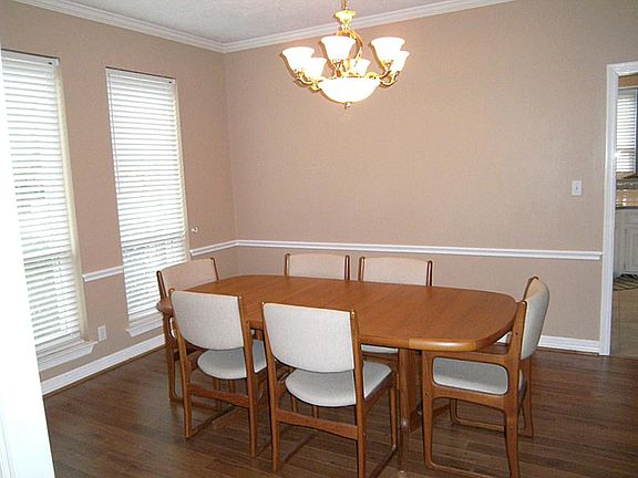Formal dining room is 14x12 and has windows overlooking the front yard.  Notice the chair-rail & crown molding. Wood laminate flooring installed 2008.  Painted 2012. This is a great room for entertaining family & friends during the holidays.