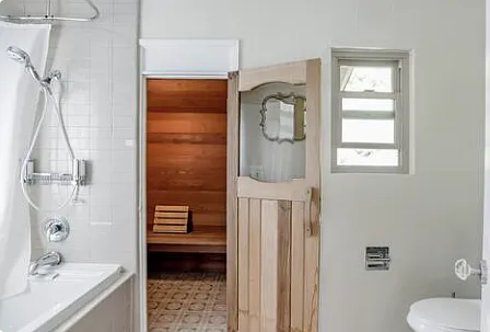 Enjoy a full private bathroom featuring a soaking jetted tub, a separate shower, and the added luxury of a steam sauna for a spa-like experience.