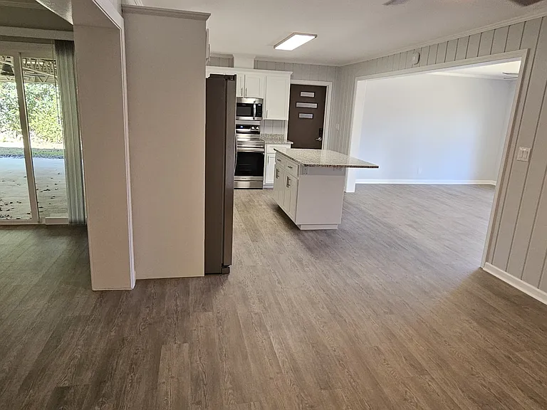 From eating area - looking toward kitchen, den (to left), & living room (to right)