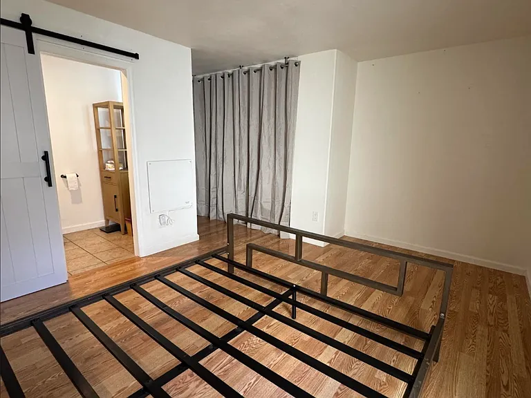 Bed frame size is California King for scale, but not included. Bedroom window faces North. Primary bathroom has sliding barn door.