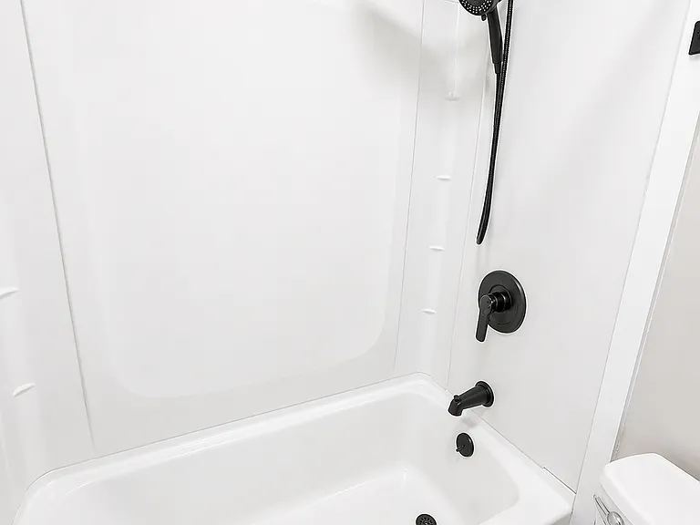 Refreshed bathroom with new fixtures, cabinets, mirror, faucet, hardware, paint.