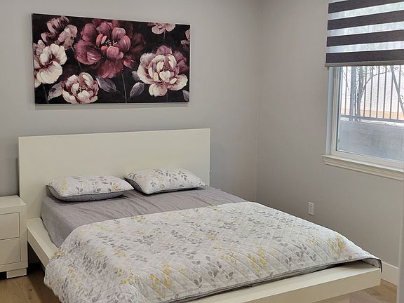 Guest Bedroom showing Queen Bed and Night Stand