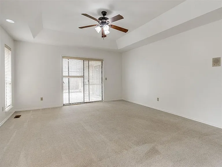 Master bedroom with door onto patio.