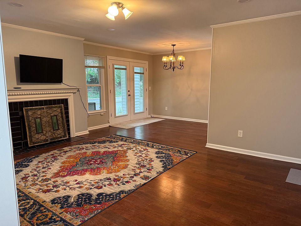 Family room and dining room are in an L shape. 11'x21' and there is a patio off of the dining room . TV stays. Rug and fireplace screens can stay or be removed.