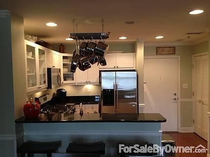 Entryway and Kitchen w/ Breakfast Bar
						:
						View from Living Room