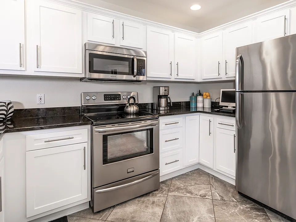 Kitchens feature stainless steel Frigidaire appliances & granite counters
