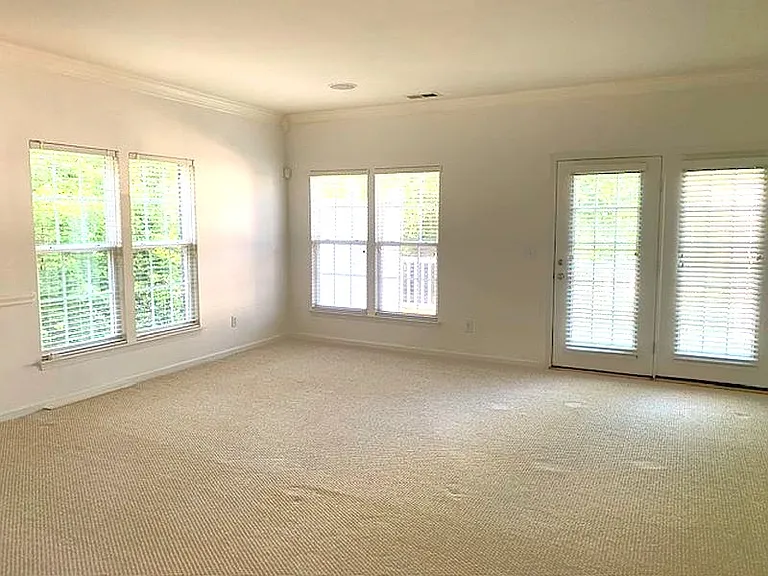 -2nd floor Large Living and Dining room. 
-Leads to the Private deck, behind the doors.
- The carpet will be replaced by LVP plank flooring.