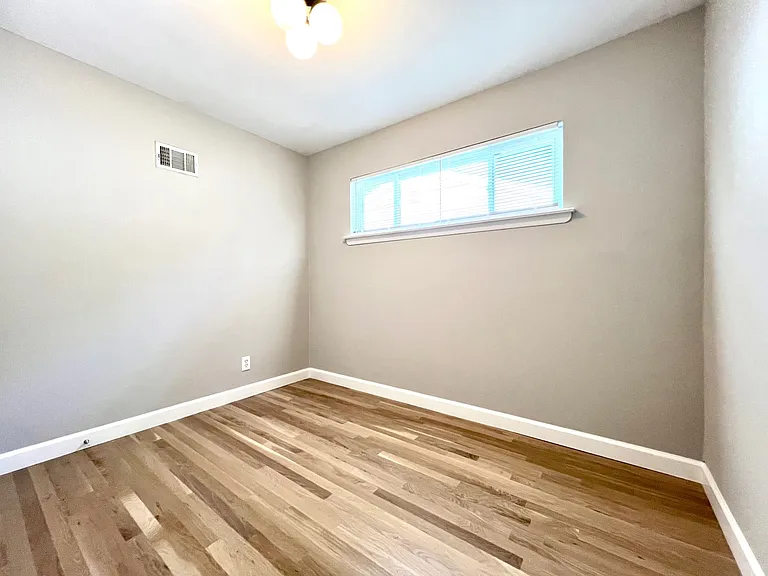 Third bedroom with dimmable overhead light.