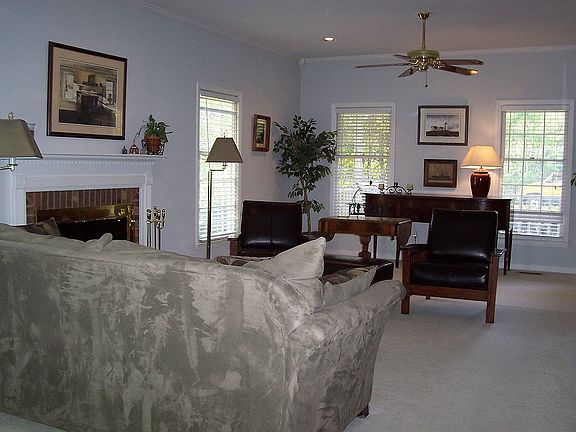 Expansive family room with crown molding, masonry fireplace. 