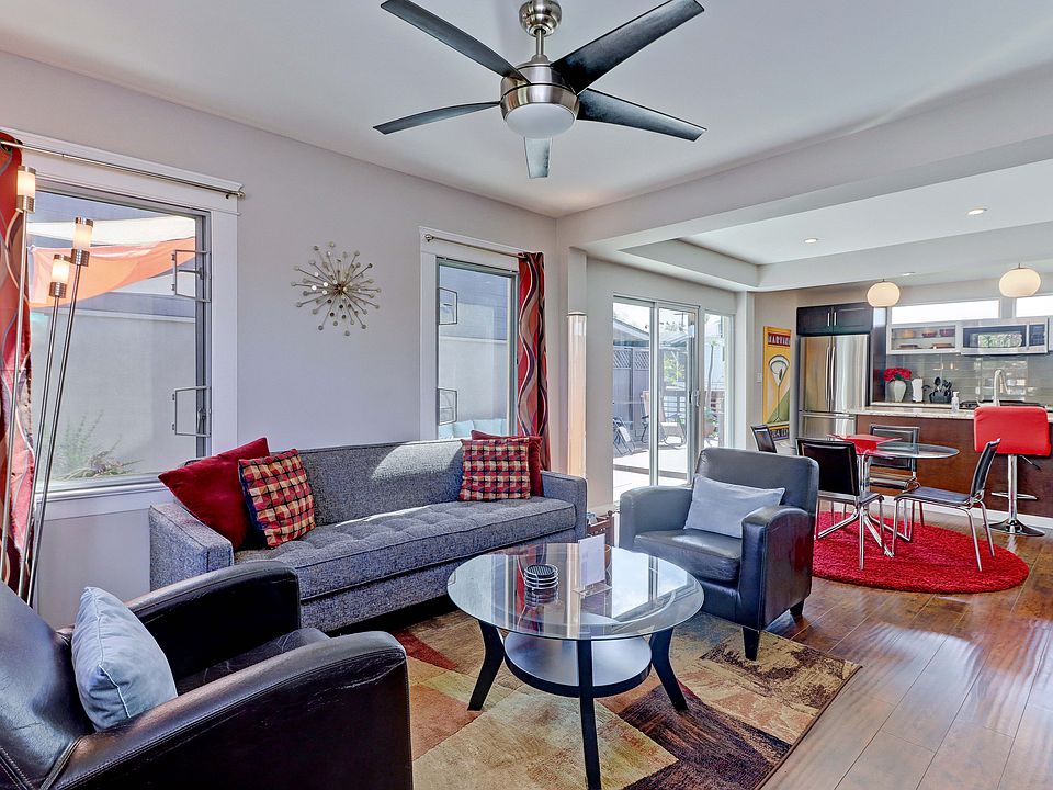 Main, street-level living room, dining room and kitchen with door to patio.