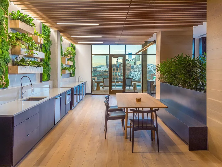 Clubroom with beautiful moss wall with dining areas and gorgeous views of Denver.
