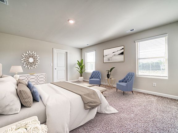 A large primary suite offers plenty of room to unwind after a long day.