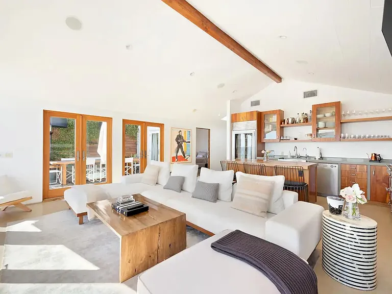 Expansive sofa with large flat screen TV.