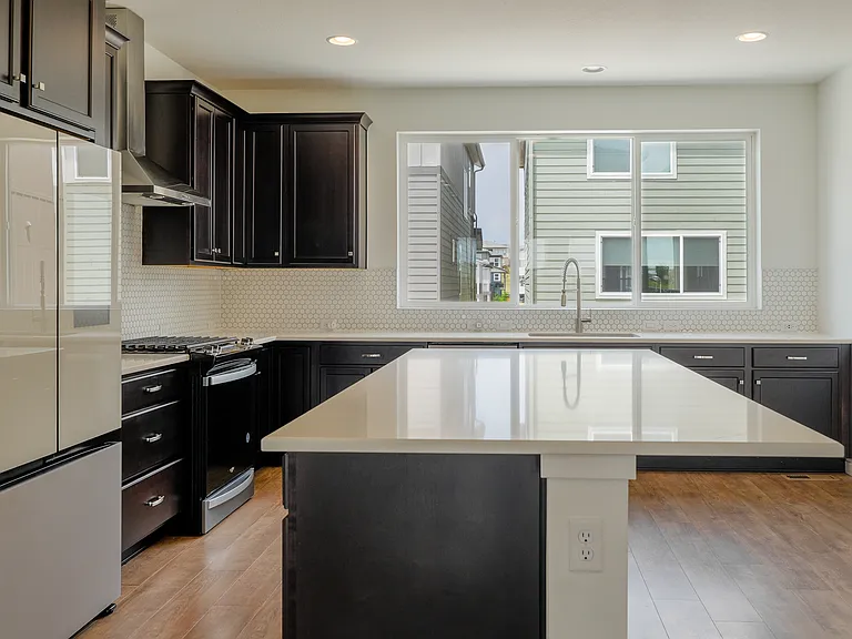 Chef inspired kitchen with oversized island, high end stainless steel appliances and Samsung Smart Hub Fridge