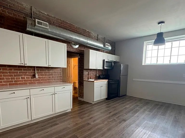 Bright kitchen layout with stainless steel appliances and ample counter space.