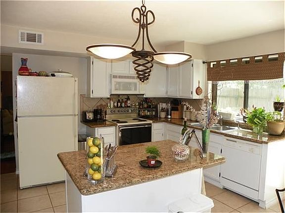 Truly a chef's paradise, this kitchen has it all from the large center island to the abundant prep space to.  Granite counters complete this room.  It is open to the breakfast area as well, so great for entertaining!