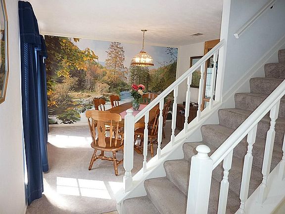 Enter onto the tiled front entry through the front door with beveled glass accent and side transoms.