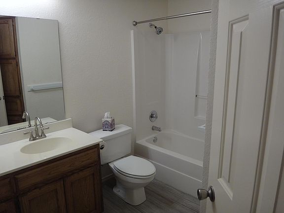 Guest bathroom with linen closet and clothes hamper.