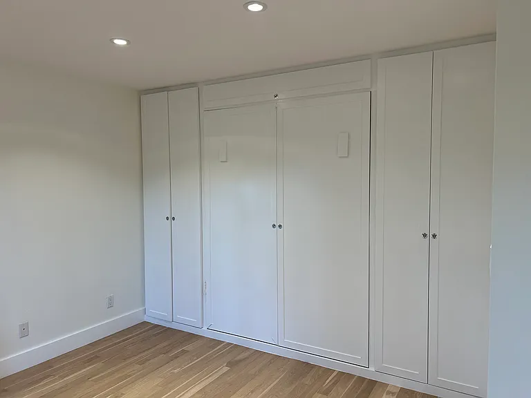 Large bedroom #2 (opposite end of hallway from primary) - Murphy bed and dual closets