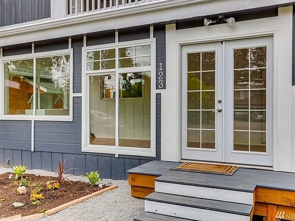 Inviting front porch has pretty french doors to welcome your guests. 