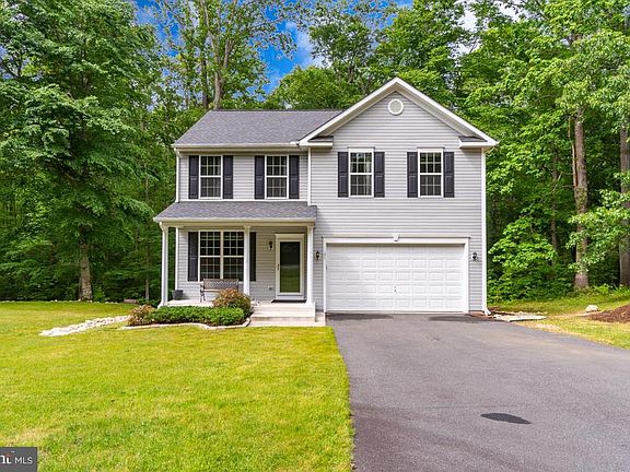 Paved Driveway, 2 Car Garage & Front Porch