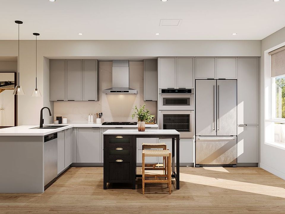 Signature Collection I 3-Bedroom Townhome kitchen with light grey cabinetry, marble quartz countertop and backsplash, upgraded stainless steel appliances, and hard-surface vinyl plank flooring throughout (Rendering)