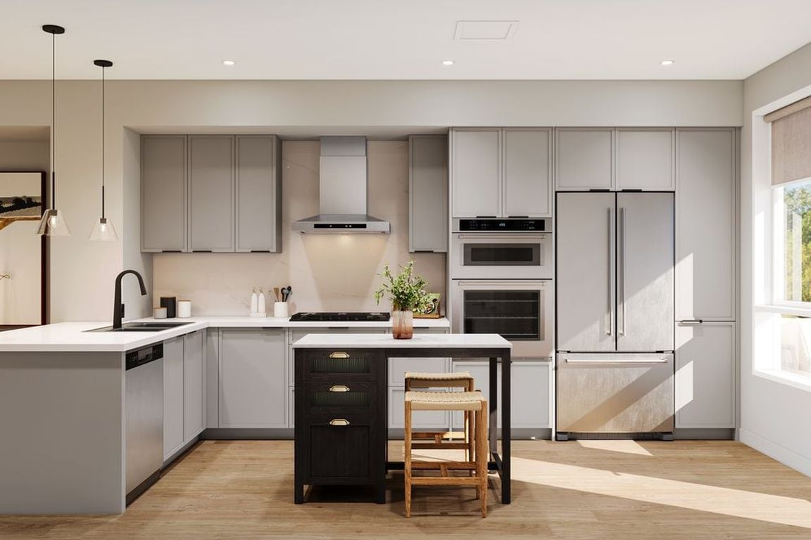 Signature Collection I 3-Bedroom Townhome kitchen with light grey cabinetry, marble quartz countertop and backsplash, upgraded stainless steel appliances, and hard-surface vinyl plank flooring throughout (Rendering)