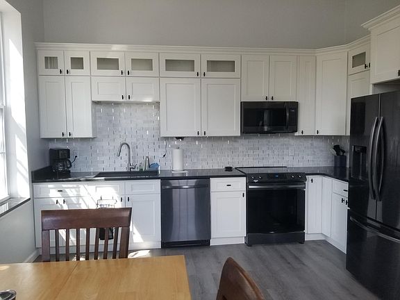 Kitchen with granite counter tops and a granite sink. Kitchen is fully equipped.