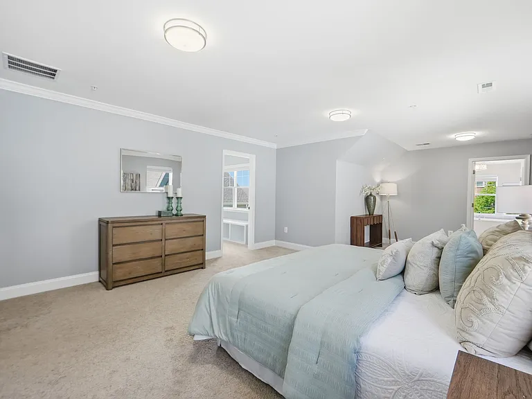 Master bedroom with sitting area, massive walk-in closet, and custom spa-like en-suite with soaking tub.