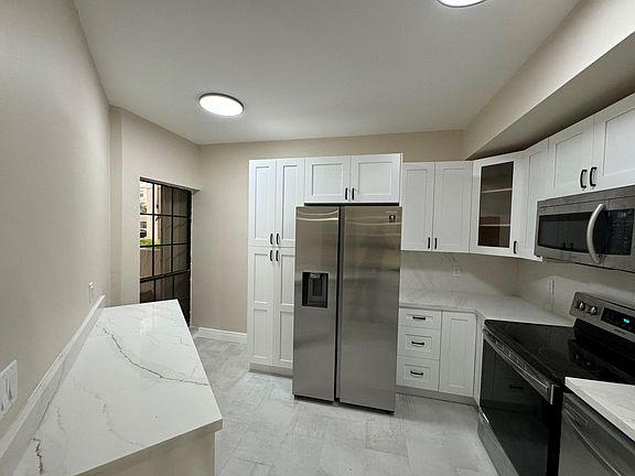 Kitchen
Corner window area is perfect for a baker's rack or indoor herb garden. Kitchen countertop workstation has great storage underneath.