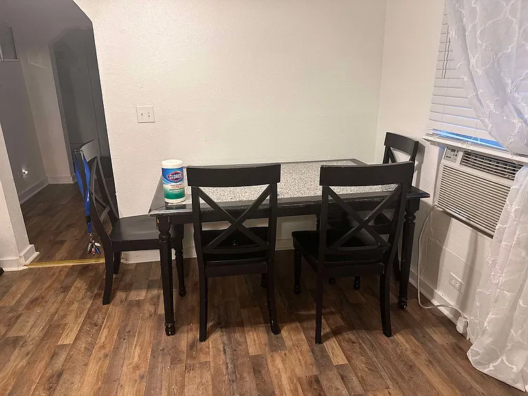 Eat-in dining area; arch leads to kitchen, 2nd bedroom, bathroom, and laundry area.