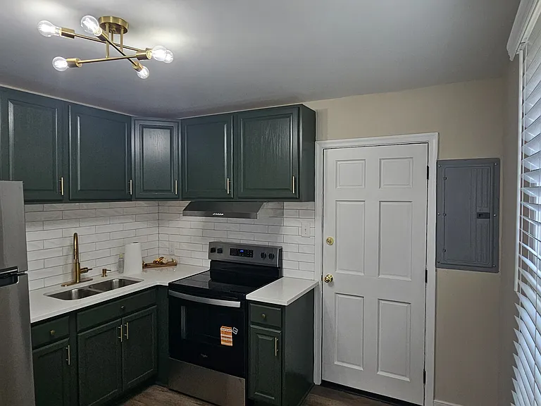 Newly renovated kitchen with new backsplash, flooring, appliances, fixtures and cabinets