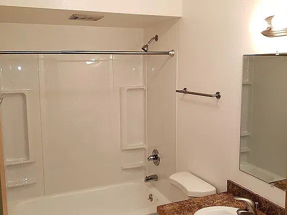 Shared bathroom with designated cabinet space for personal items.