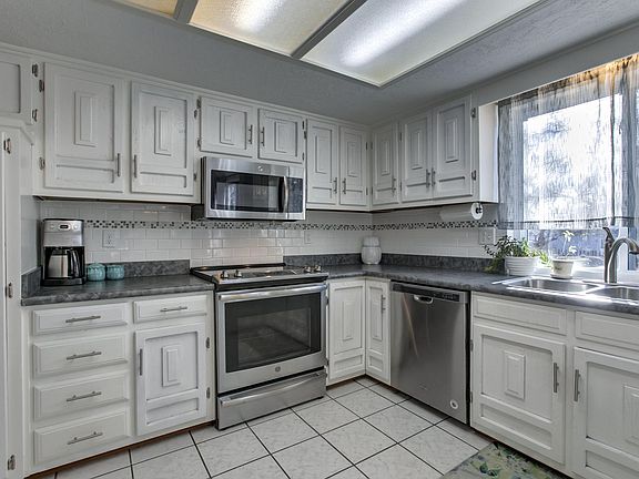 The kitchen has updated cabinets and stainless steel appliances throughout.