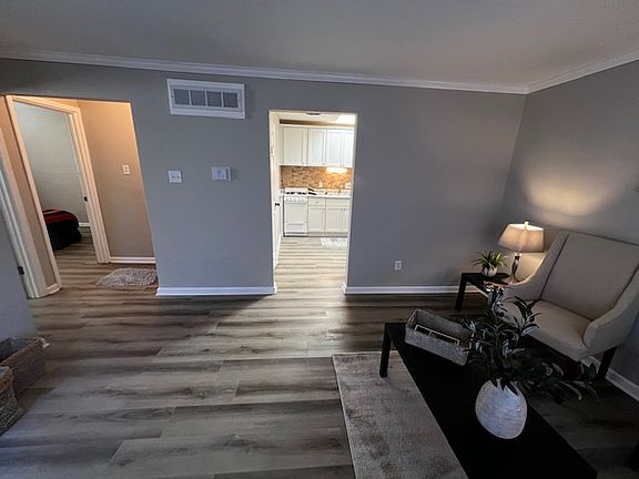 Living room to kitchen straight ahead, left to bedrooms