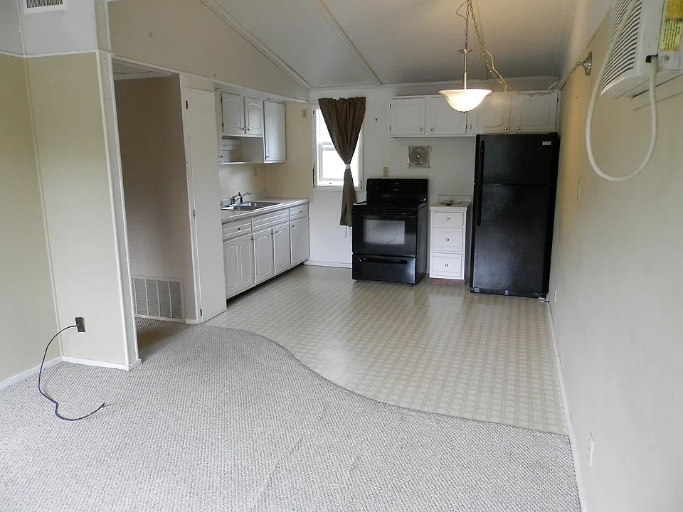 Living room (foreground) and kitchen/dining area.