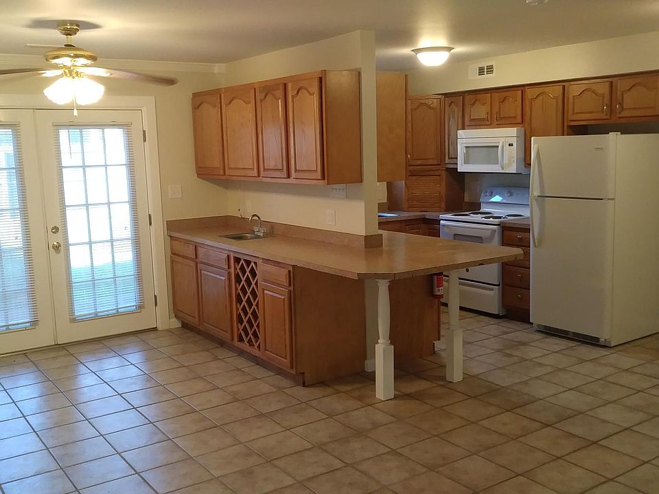 Open floor plan with additional cabinets and bar area.