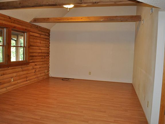 exposed log wall in living room