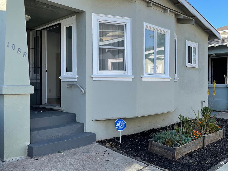 Front of house in a well-lit courtyard off the street