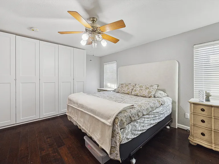 Large primary suite with room for a workstation or reading nook, featuring an en-suite bath, walk-in closet, and custom IKEA PAX organization system.