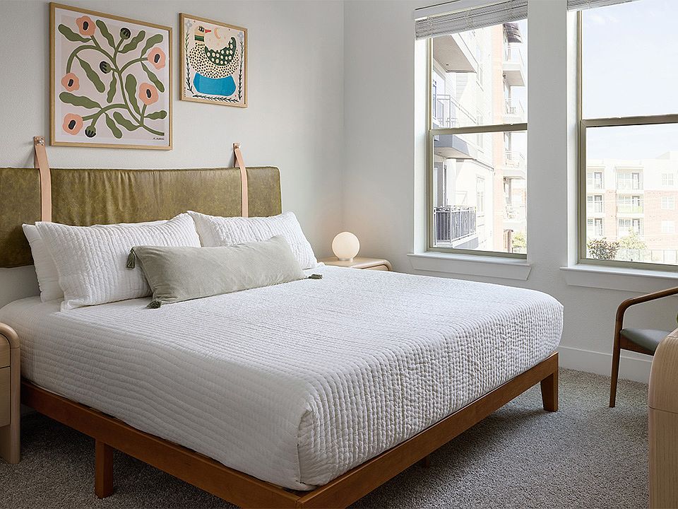 Spacious apartment Bedroom with plush carpet flooring.