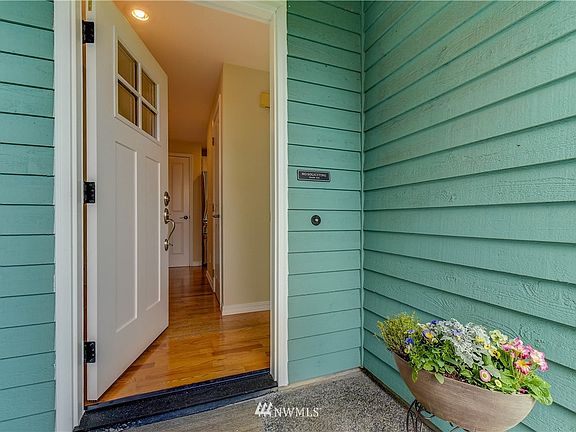 Front door opens to gleaming hardwood laminate.