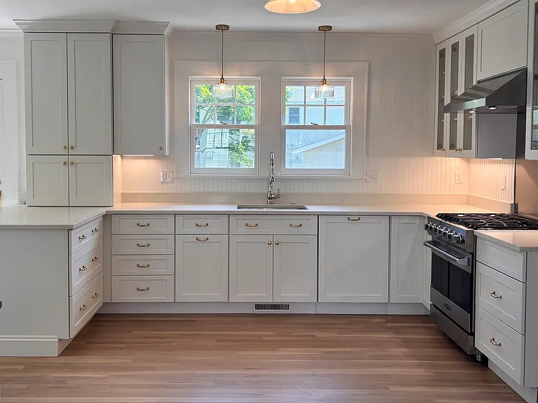 Kitchen all-wood cabinets and unlacquered brass hardware.
