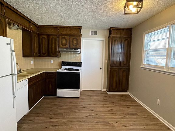 Sizeable kitchen that leads to back utility room and back entrance.