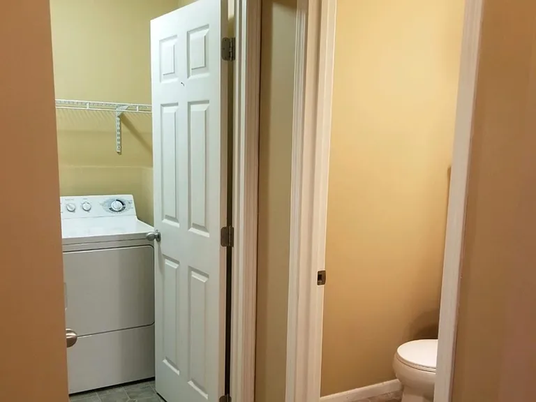 laundry with washer dryer and next to half bath