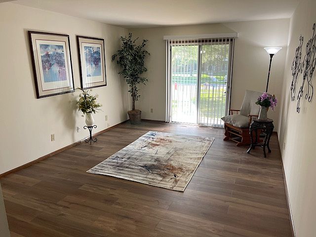 Large living room with patio door leading to a beautiful outdoor patio